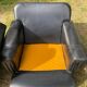 Pair of black imitation leather armchairs