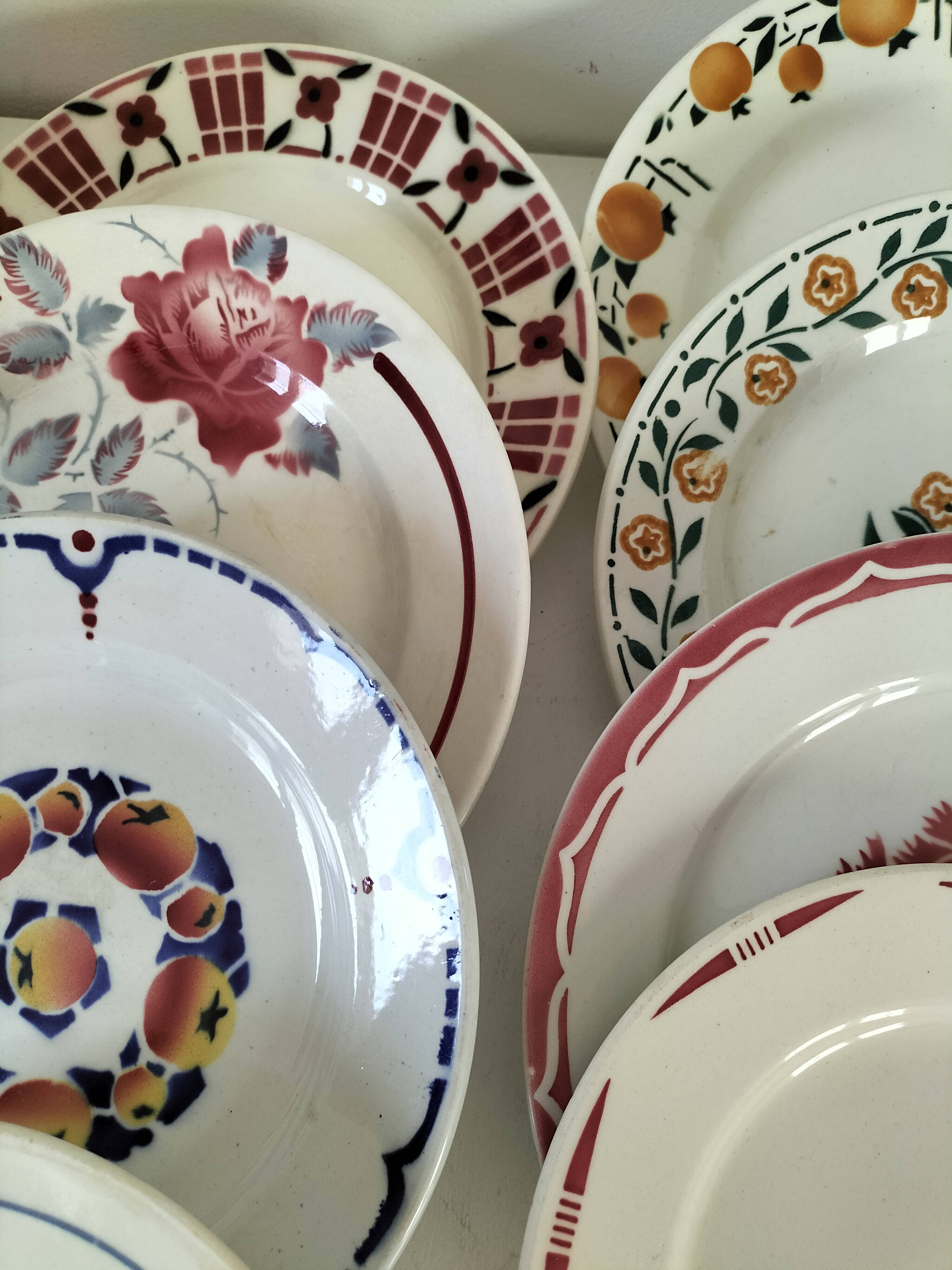 Set of 8 ironstone plates with coordinated designs.