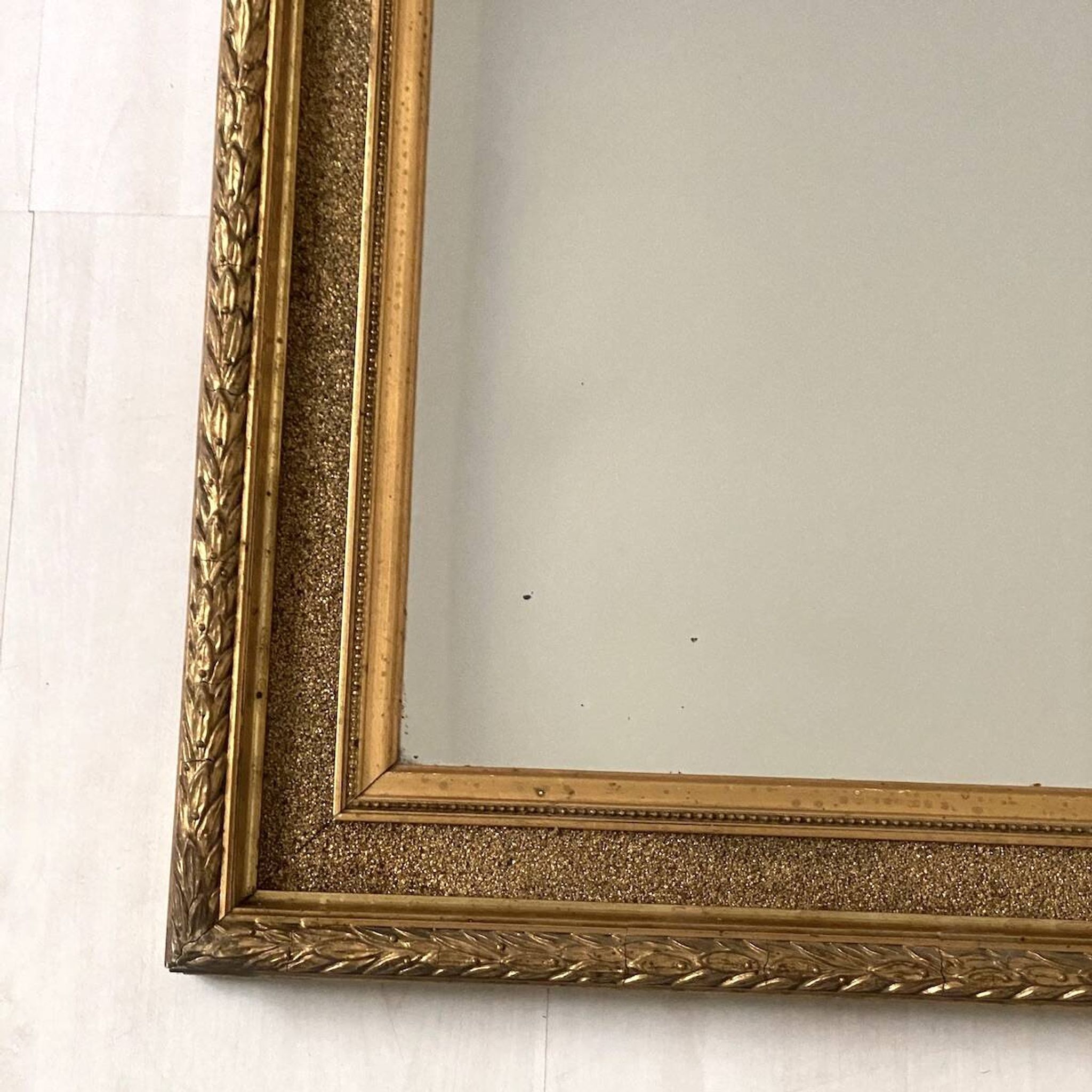 Small wooden mirror with gilded stucco in the Louis XVI style.