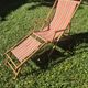 vintage wooden deck chair with striped fabric and footrest