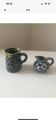 Set of two small Vallauris yellow and black milk jugs