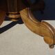 Old walnut table with a central leg.