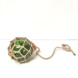 Green ball marine float in glass and rope
