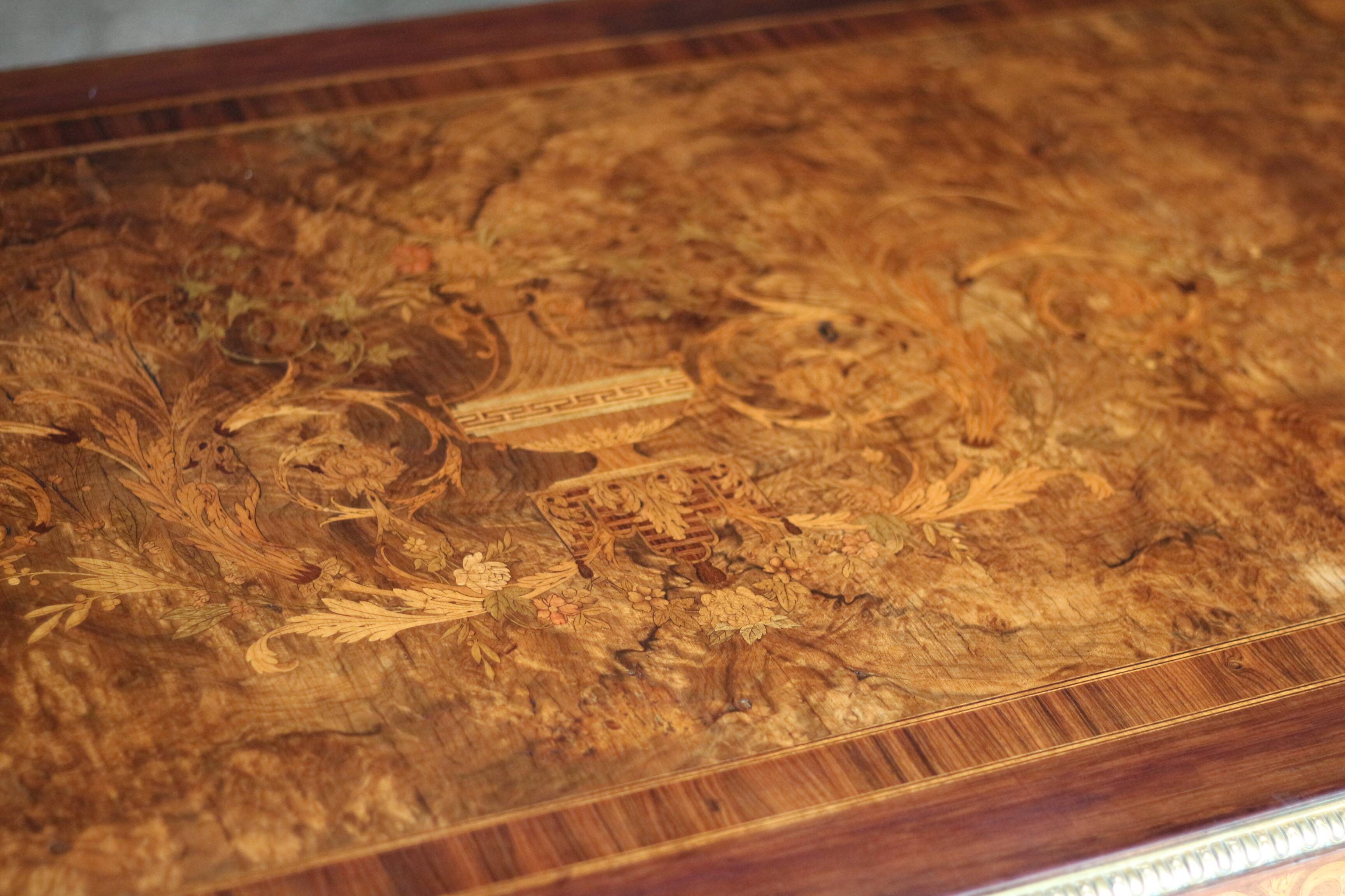Superb Napoleon III table. Marquetry top and gilded bronzes.