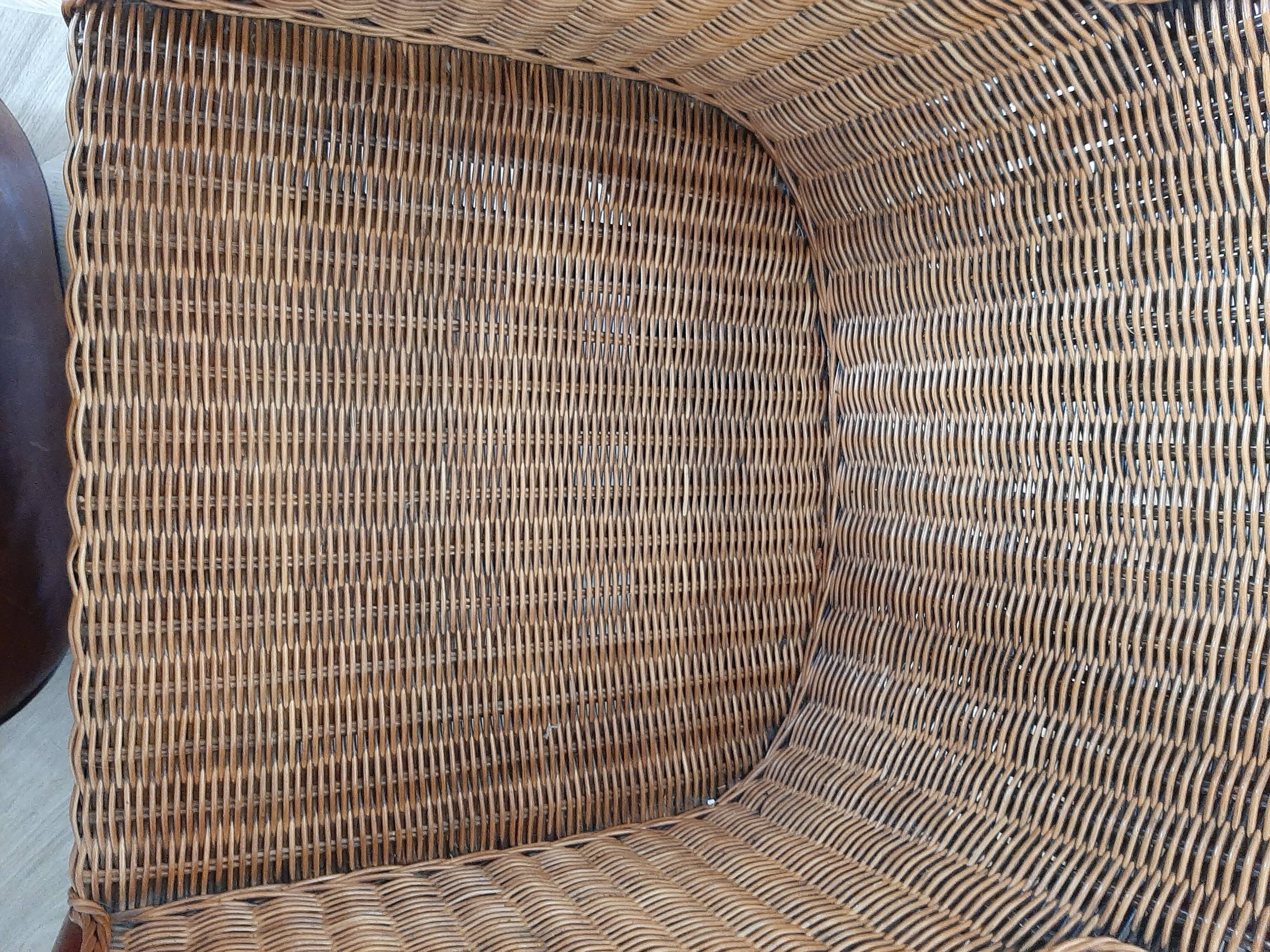 Armchair in woven rattan and exotic wood