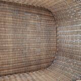 Armchair in woven rattan and exotic wood
