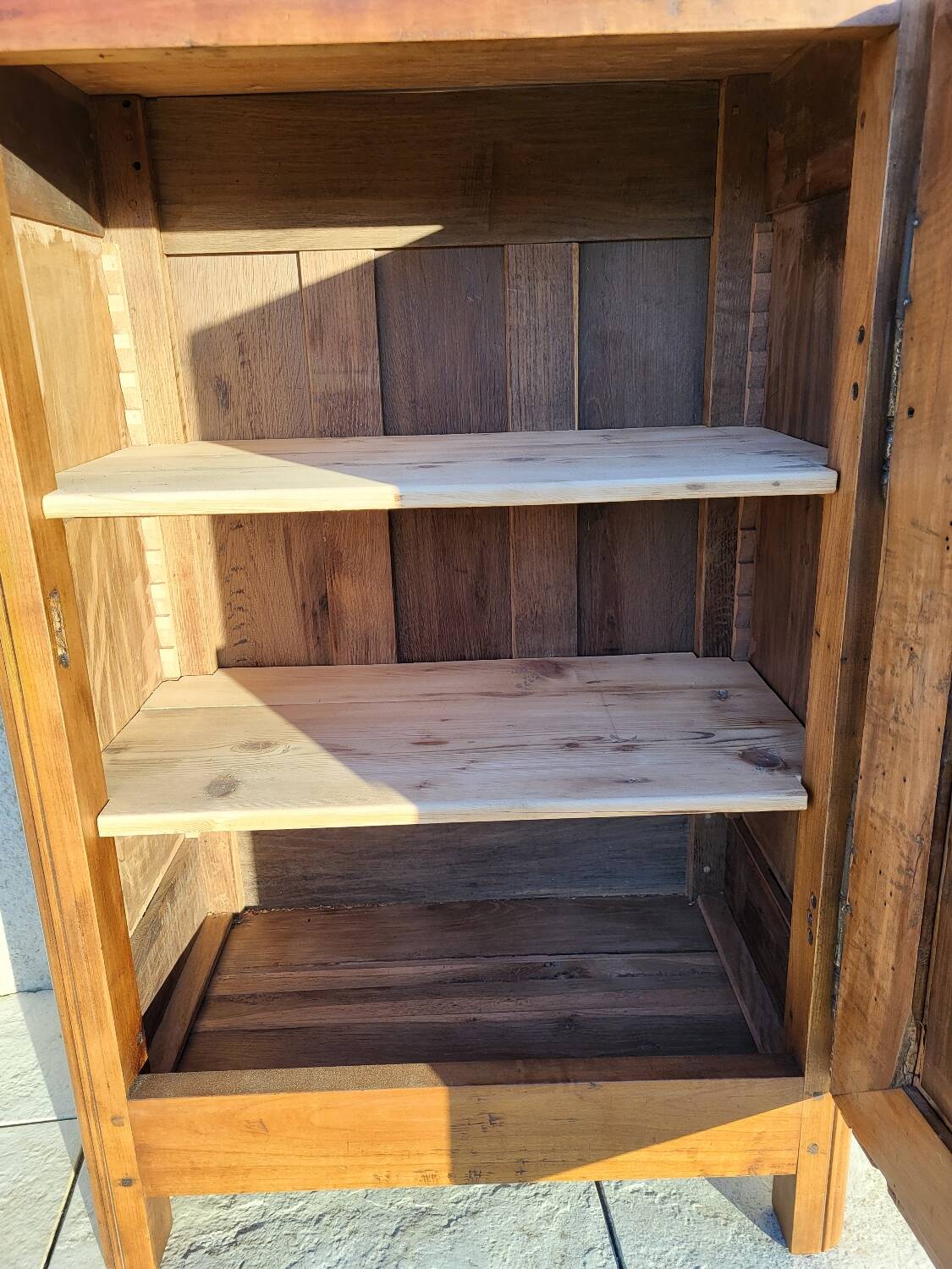 Furniture with a cherry wood door.