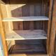 Furniture with a cherry wood door.
