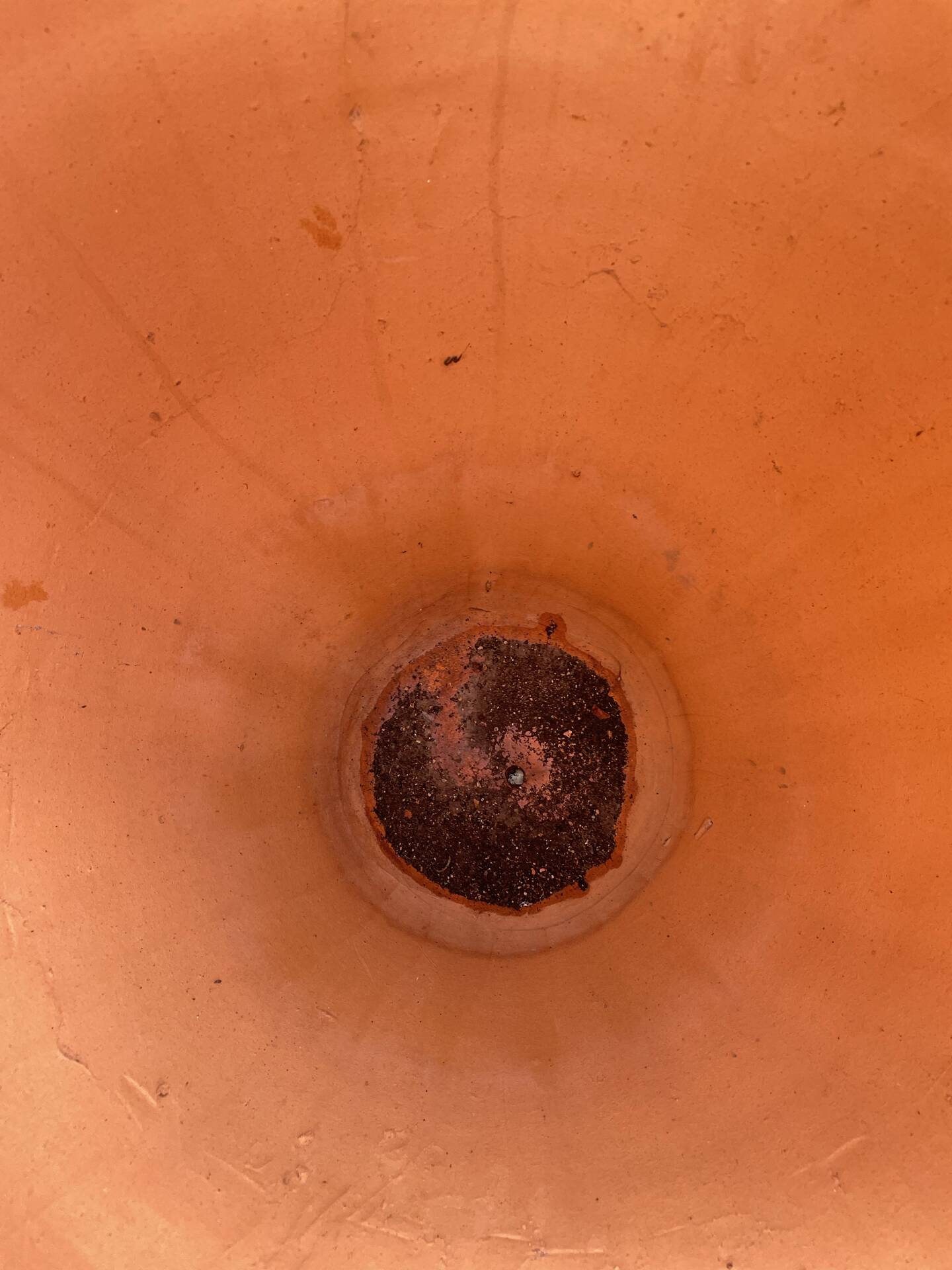 Large Cretan jar in terracotta with three handles on a stone base.