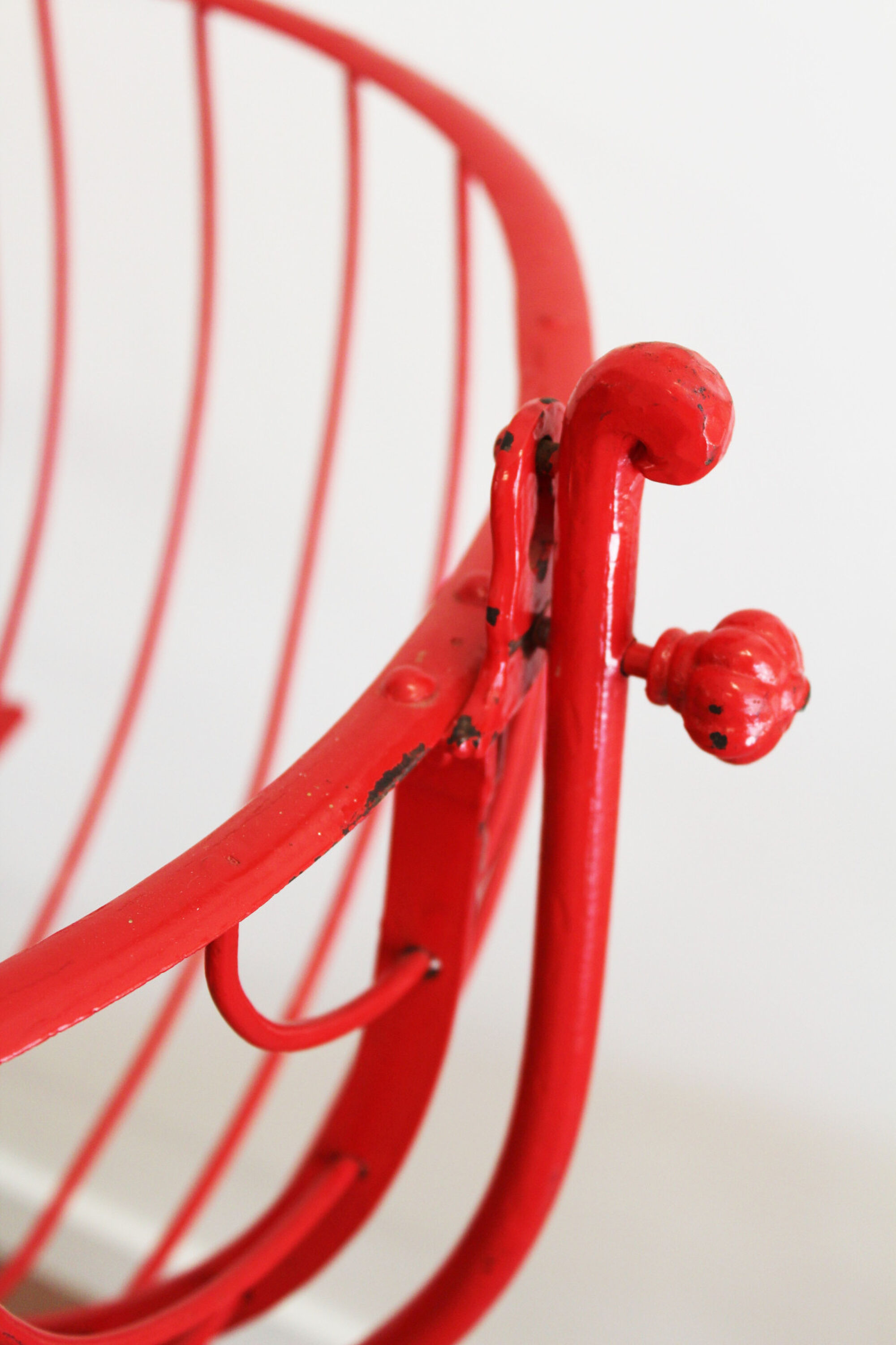 Baby cradle in red wrought iron