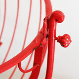 Baby cradle in red wrought iron