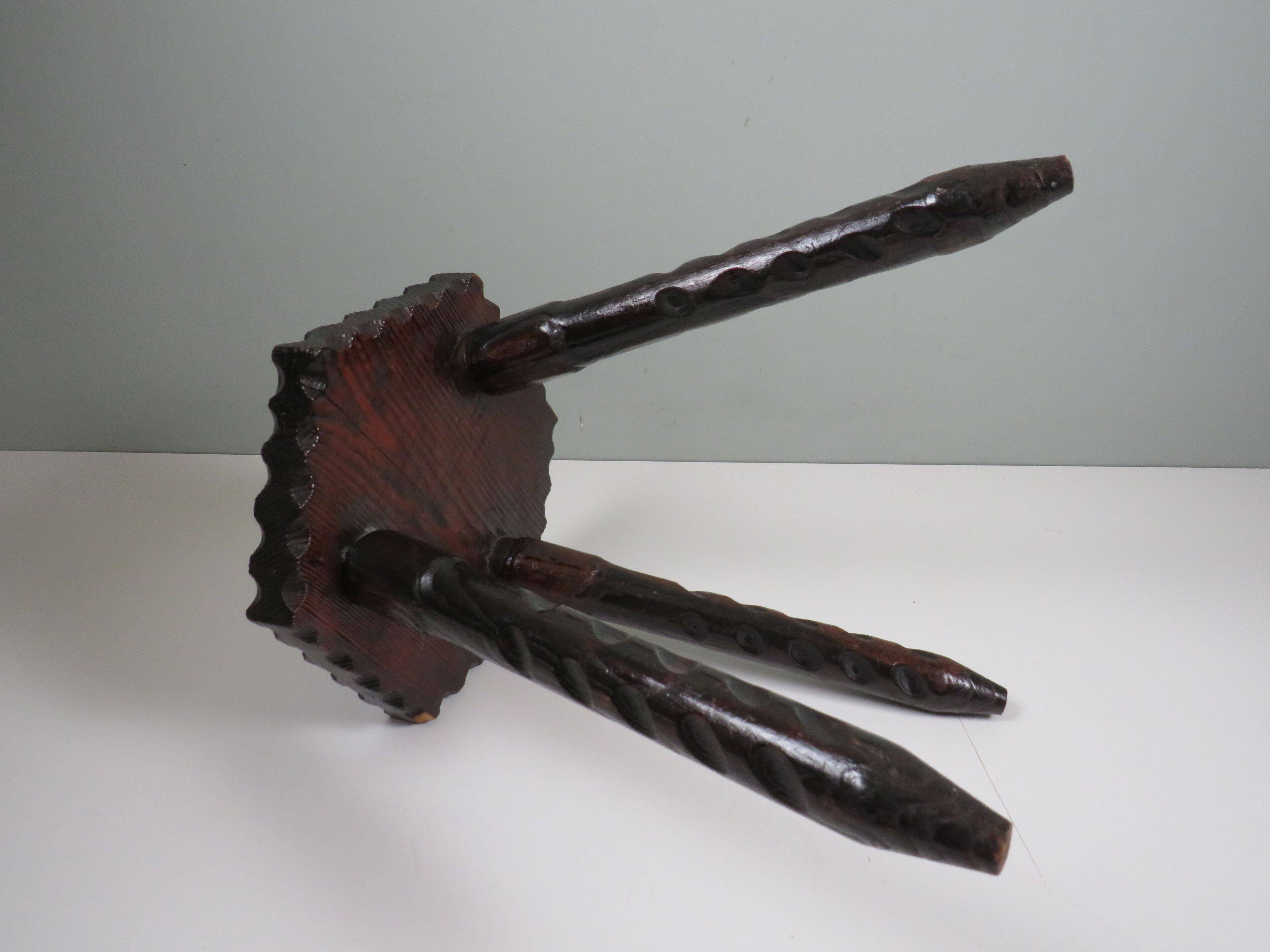 Vintage Spanish stool in carved wood with a leather seat.