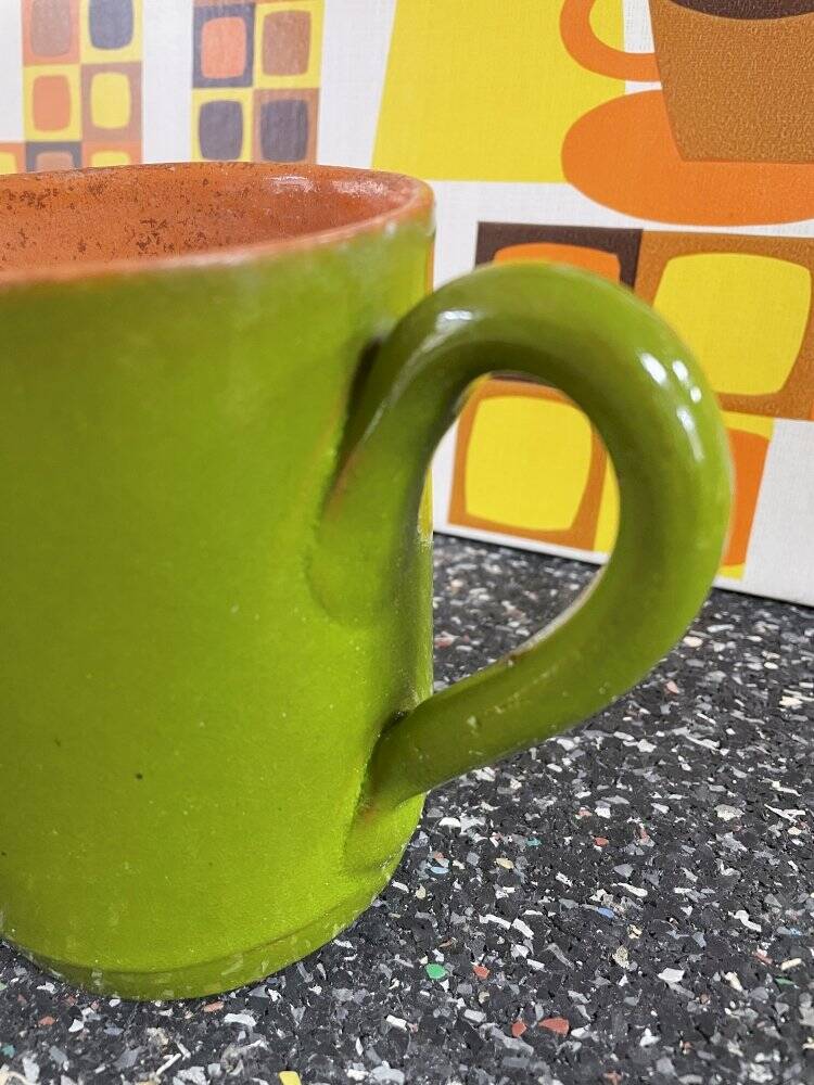 Small two-tone green glazed terracotta jug, height 12 cm.