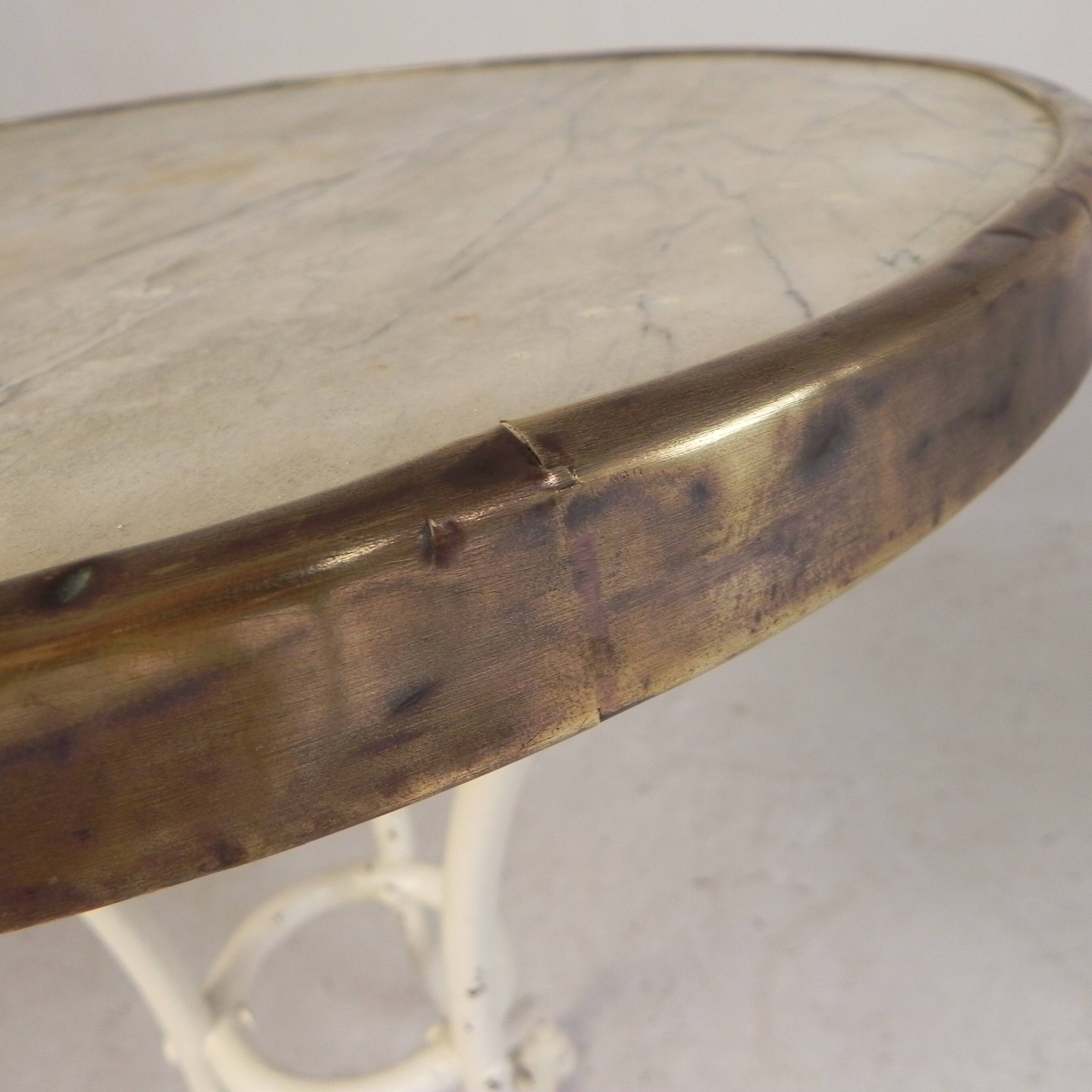Bistro table with a marble top and brass edging, early 20th century.