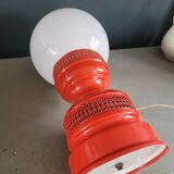 Vintage globe lamp with a metal base, perforated and lacquered in red.