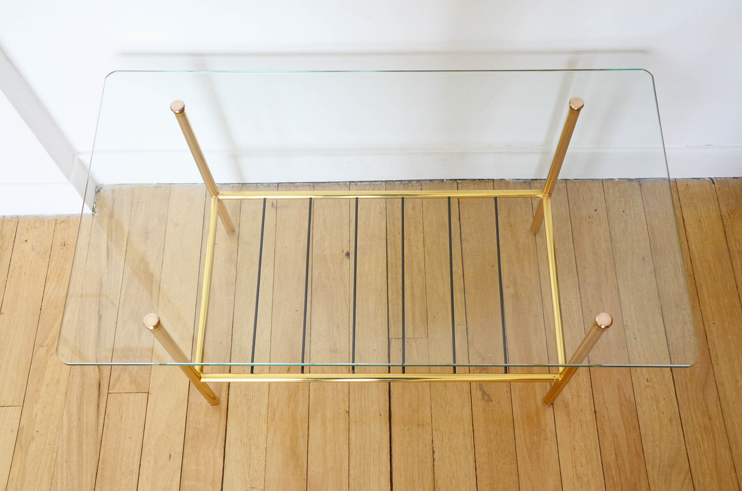 Glass coffee table with magazines holder