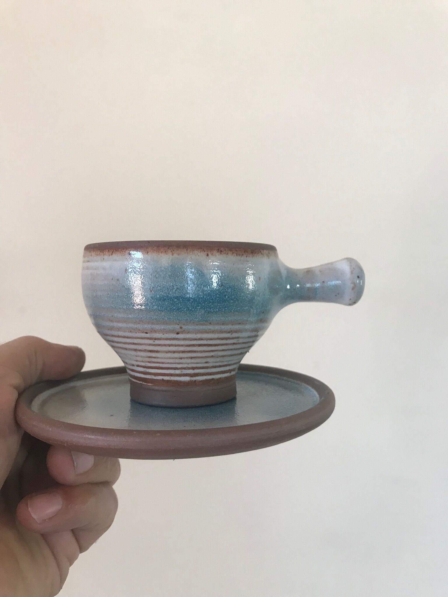 Lot 7 cups and saucers sandstone by Roger Jacques