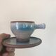 Lot 7 cups and saucers sandstone by Roger Jacques