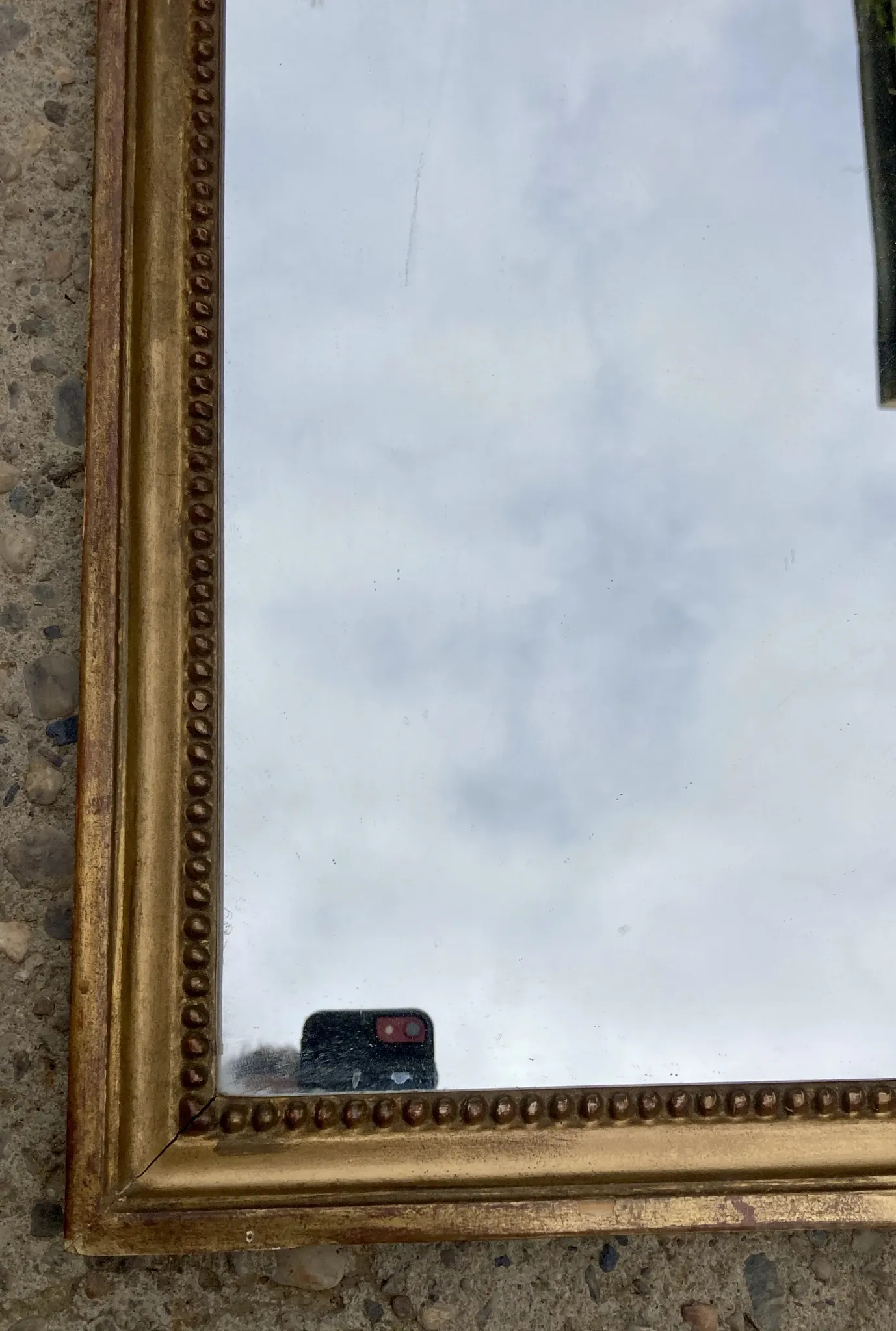 Antique mirror in wood and gilded stucco with a pediment - in the style of the 18th century.
