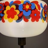 Table lamp with a vintage “flower power” glass globe and a gold base
