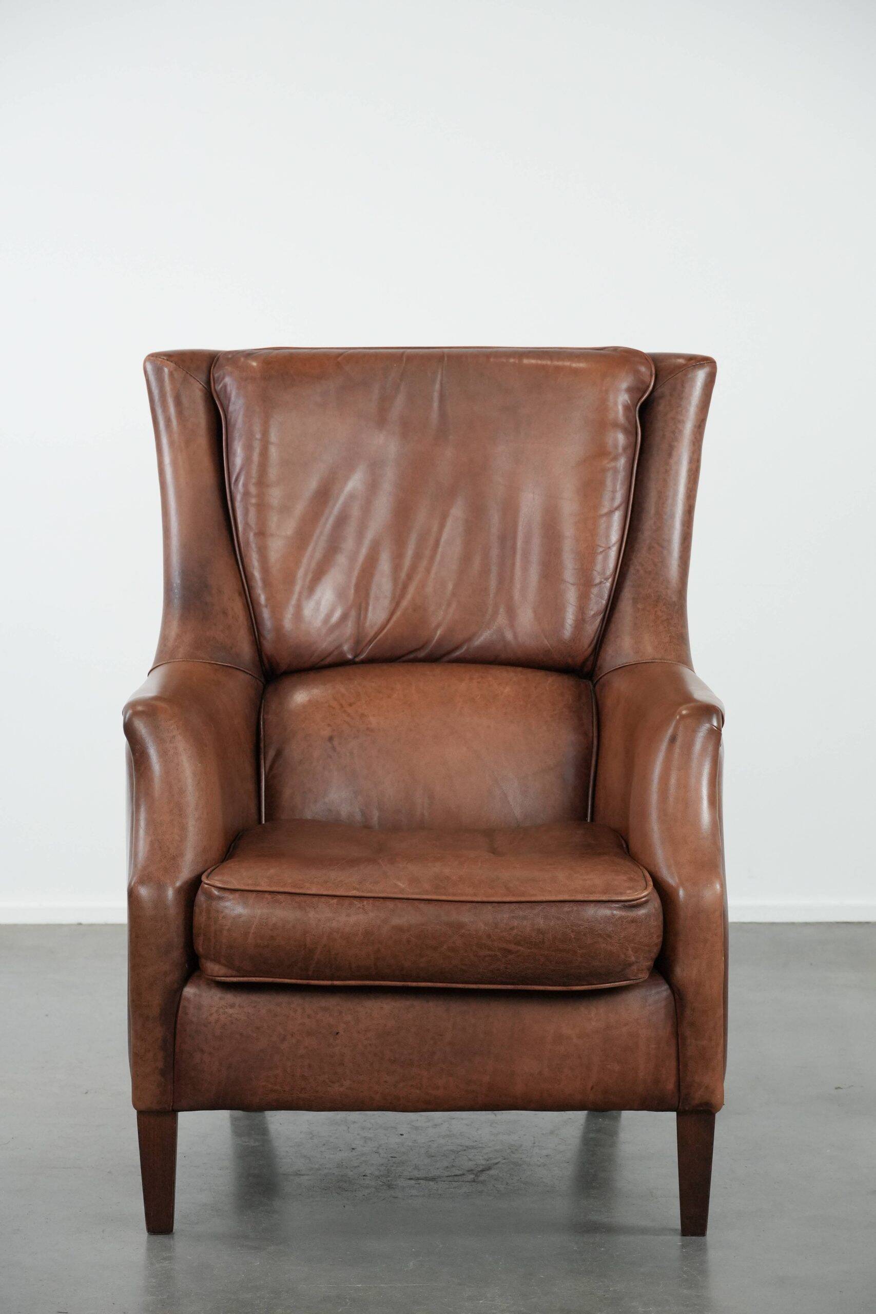 Cognac brown cow leather armchair with decorative nail finish