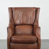 Cognac brown cow leather armchair with decorative nail finish