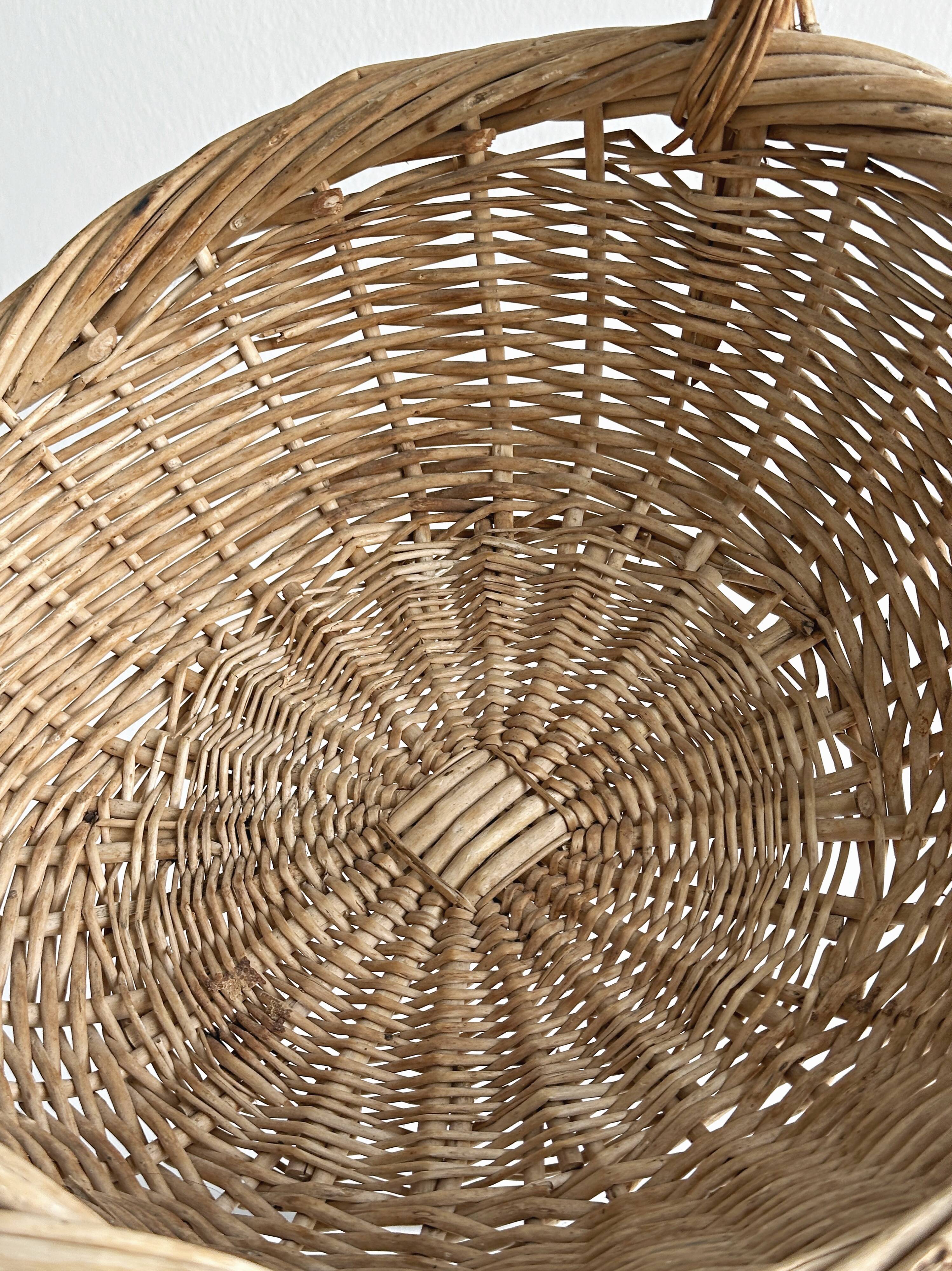 Large antique woven wicker basket with handle.