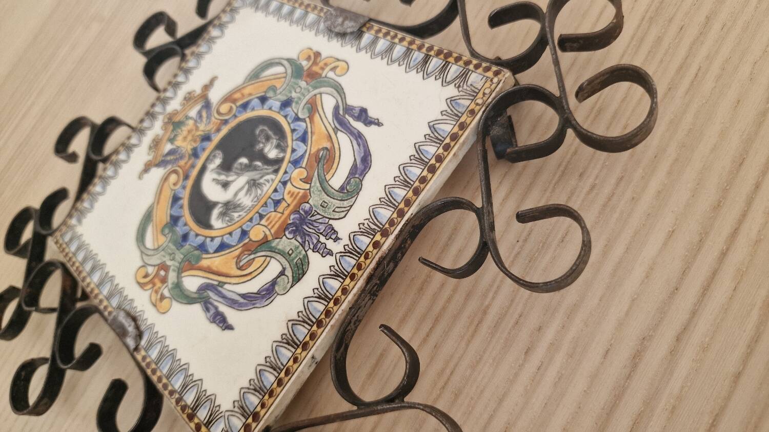 Hand painted gien tile on wrought iron trivet