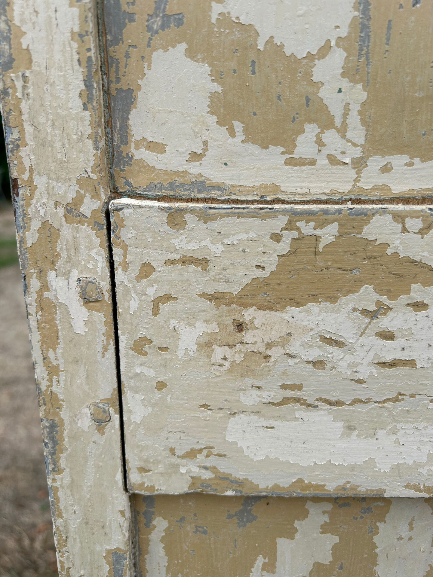 Small antique wardrobe with a faded white patina.