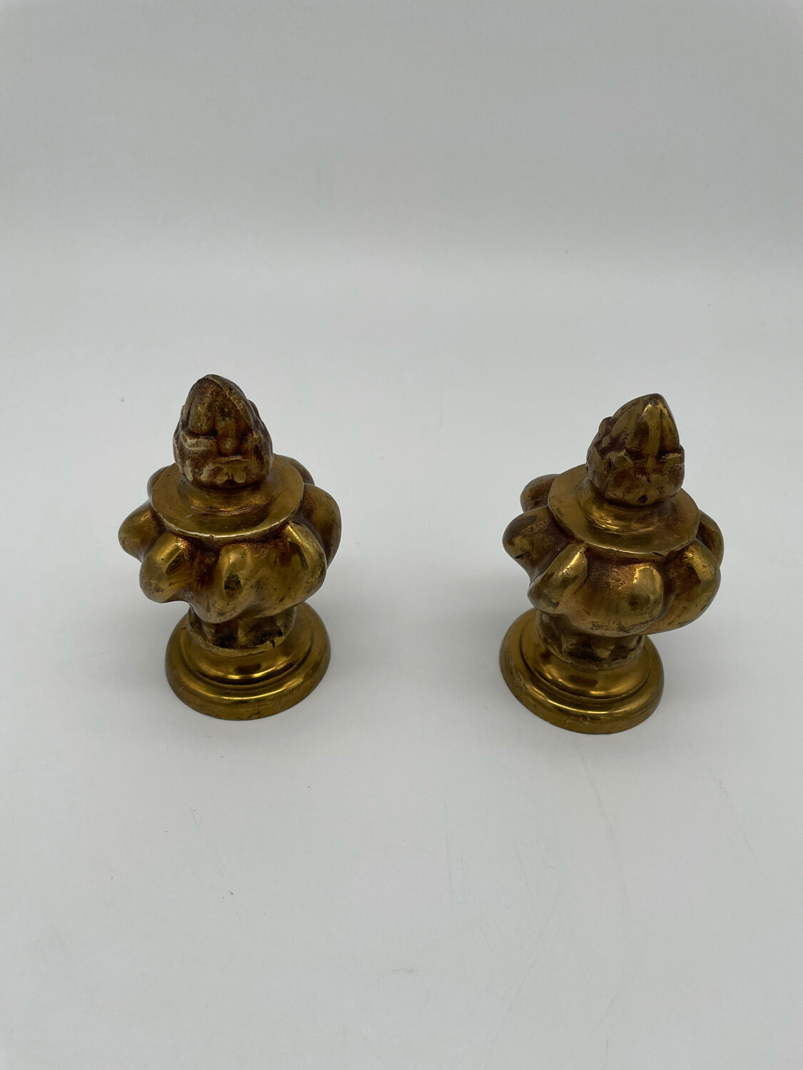Pair of antique flame curtain rod finials in gilded bronze