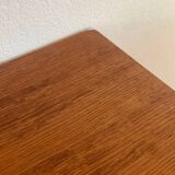 Vintage 1960s chest of drawers with covered handles.