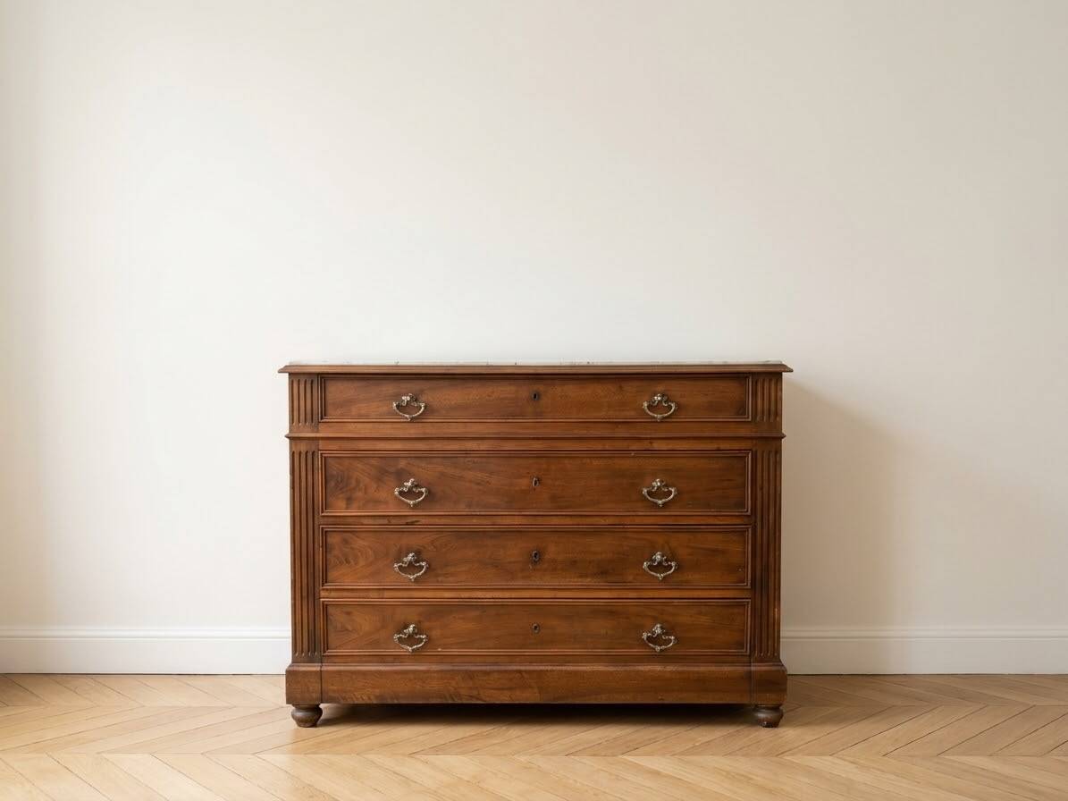 Antique wooden chest of drawers with a marble top.