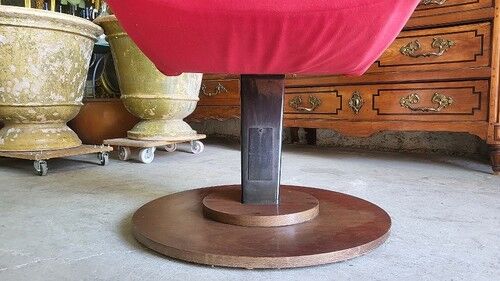 Old cinema chair with a red reclining seat.