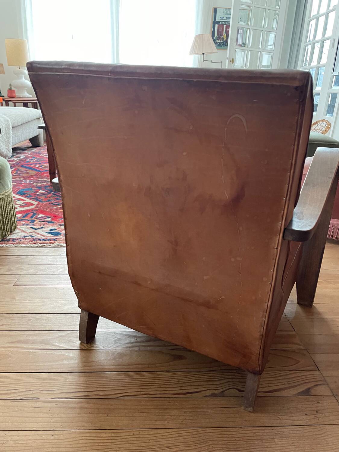 Vintage leather club chair with wooden armrests