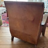 Vintage leather club chair with wooden armrests