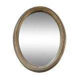 Classic oval mirror in gilded wood.