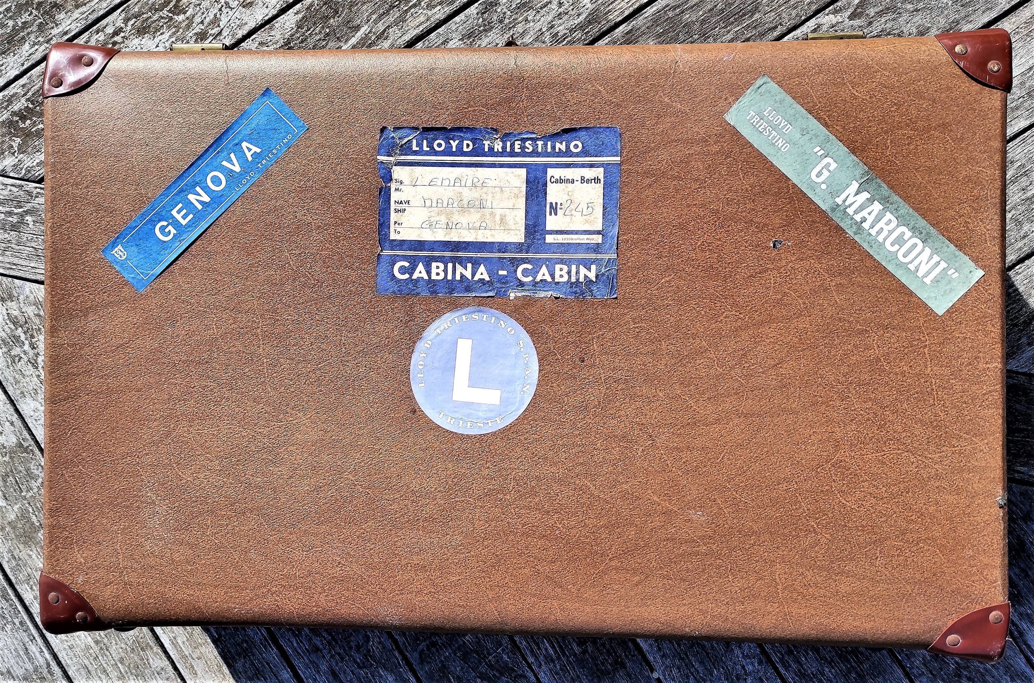 Brown vintage suitcase with CHENEY England brand travel tags