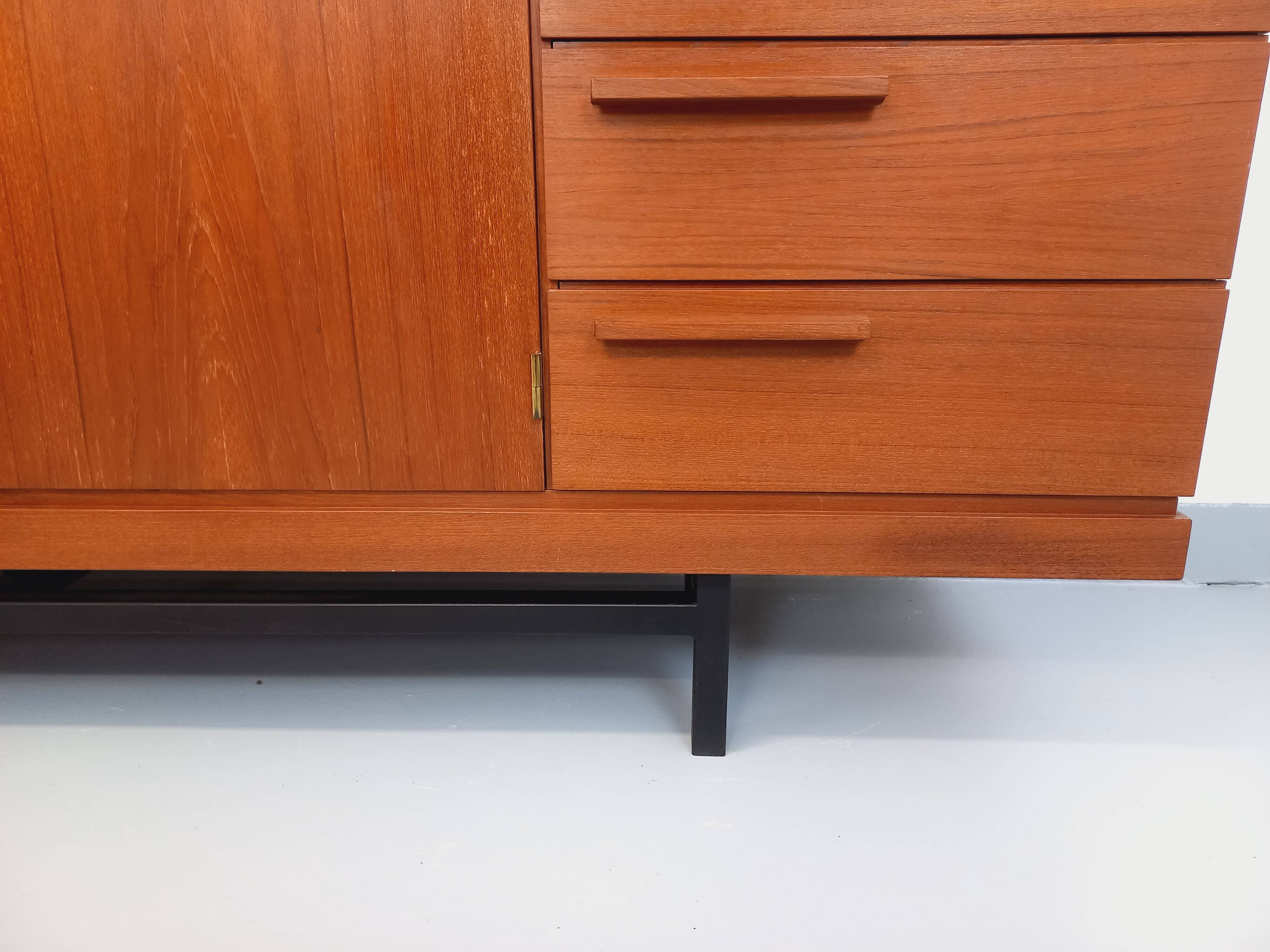 High Scandinavian modernist vintage sideboard in teak and black metal.