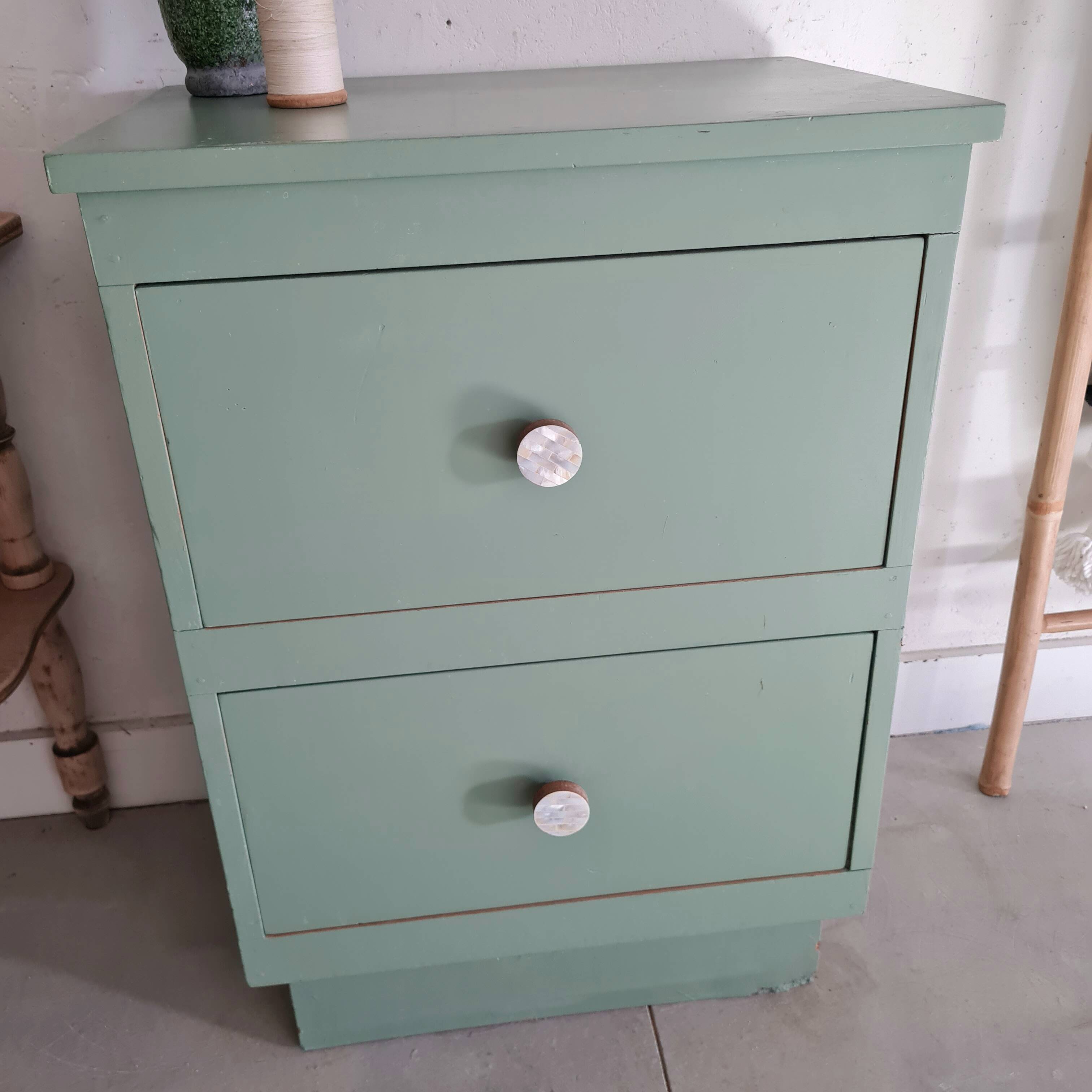 Old chest of drawers with two green drawers