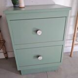 Old chest of drawers with two green drawers