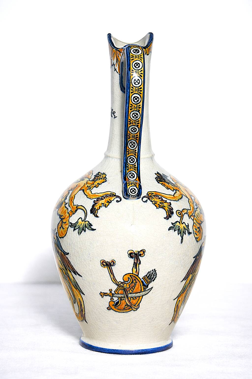 Gien earthenware jug, Renaissance decoration, putto with dolphin.