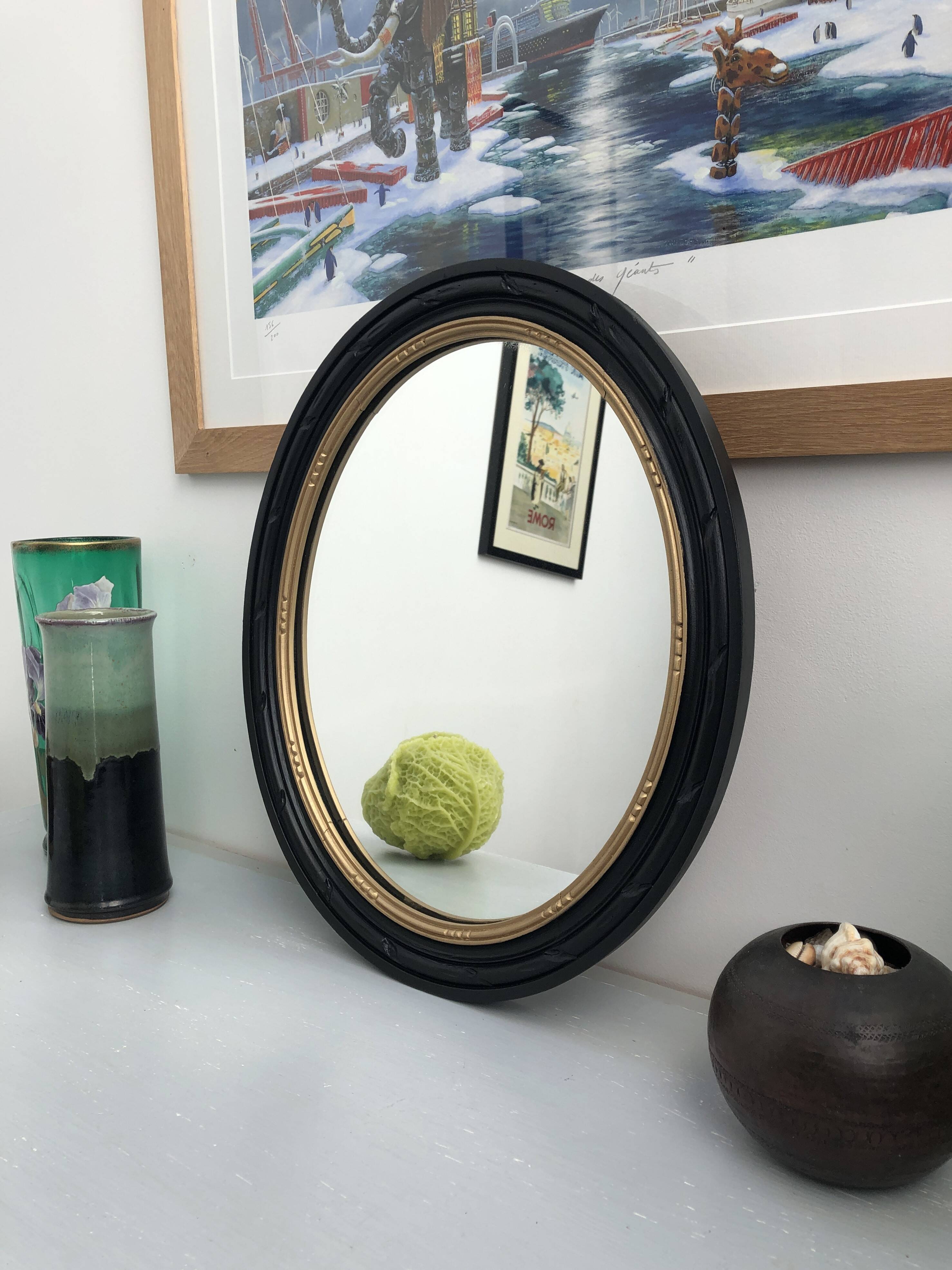 black and gold oval mirror