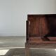 Small low armchair in varnished brown wood
