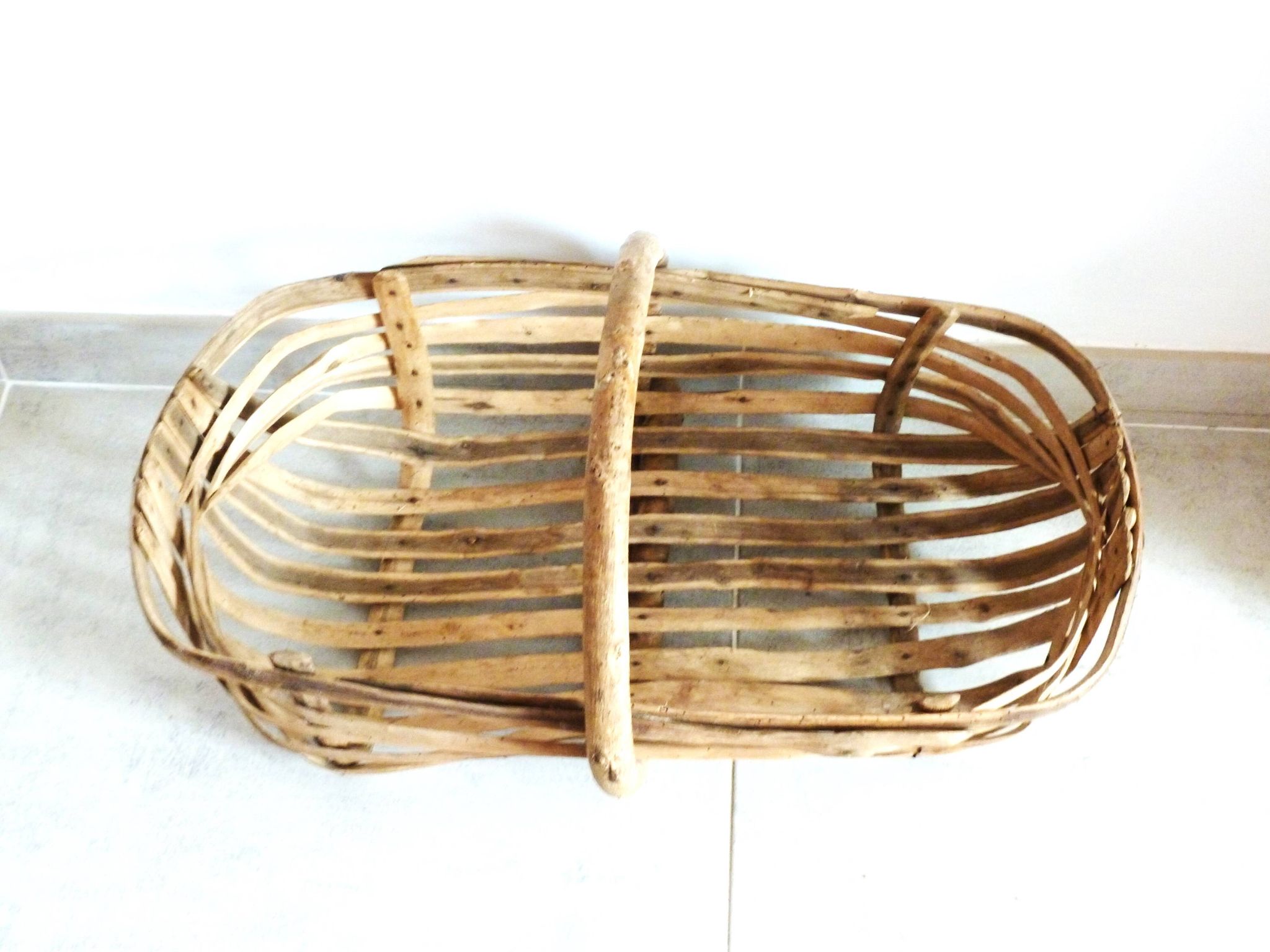 Old wooden harvest basket, slatted wooden basket, folk art.