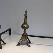 Pair of chiselled bronze and wrought iron fire dogs in the Louis XVI style.