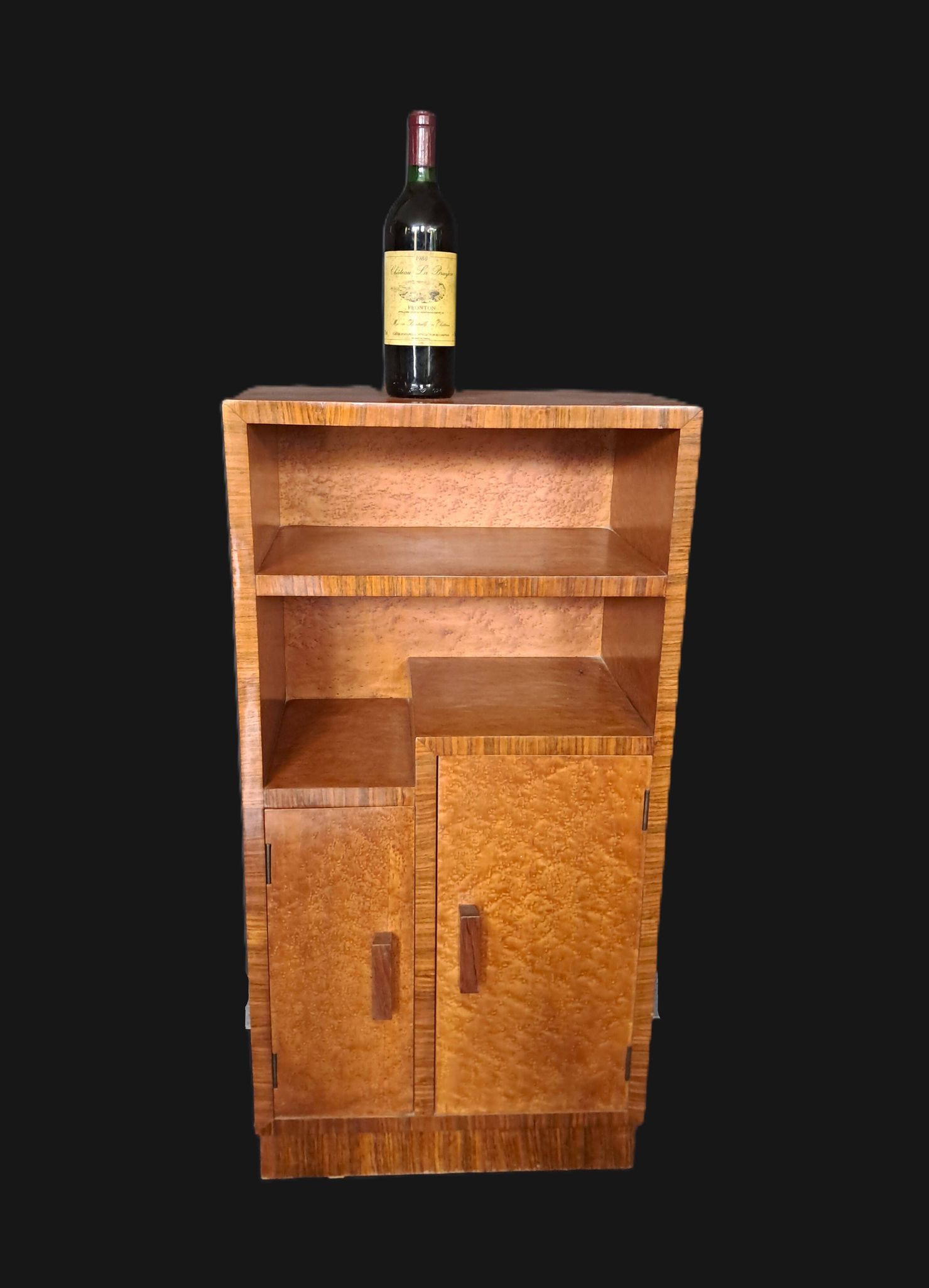 Art Deco cabinet in speckled maple veneer with asymmetrical shelves.