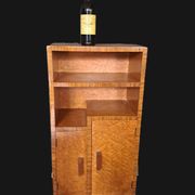 Art Deco cabinet in speckled maple veneer with asymmetrical shelves.