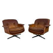 Pair of vintage cognac leather swivel lounge chairs by Eugen Schmidt