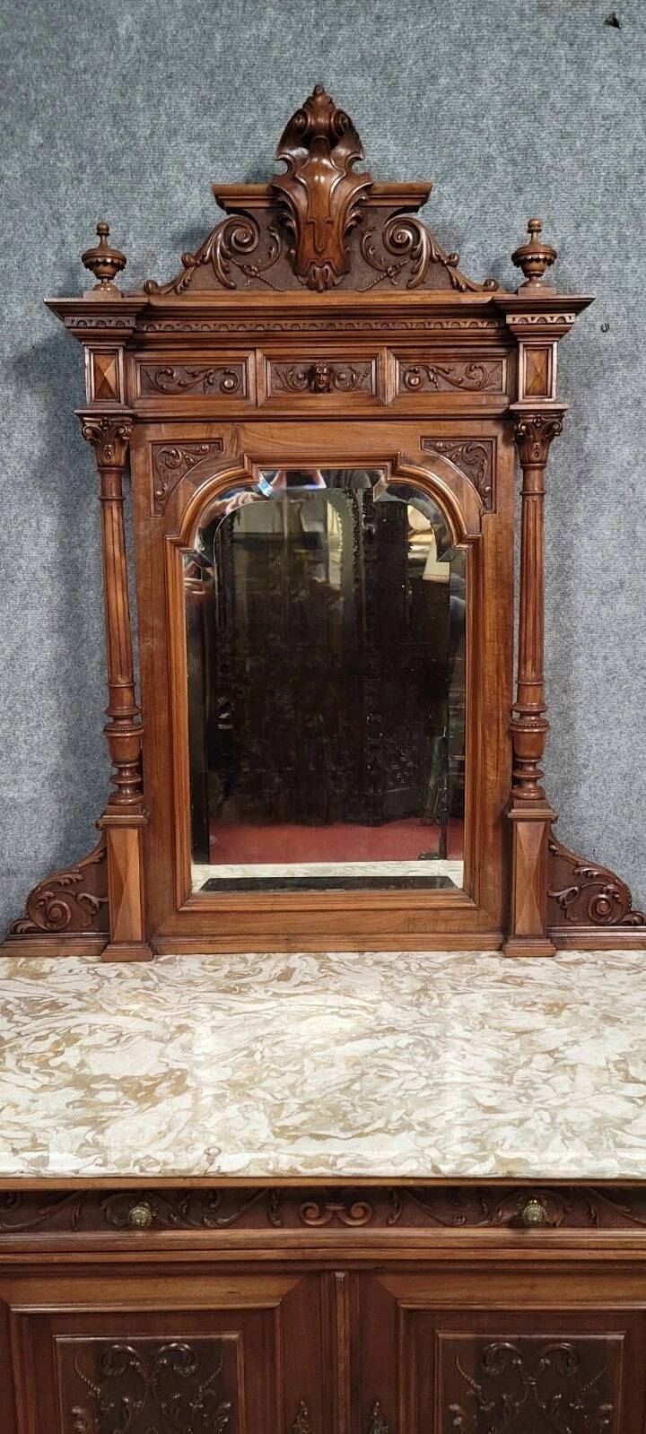 Buffet with mirror in Renaissance style, entirely made of solid walnut.