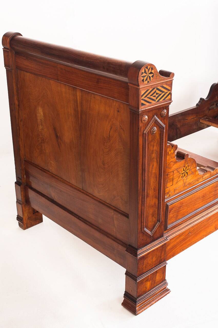 Bed made of solid walnut with marquetry details. France, 1930s.